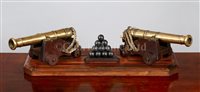 Lot 63 - A PAIR OF BRASS NAVAL GUNS MOUNTED AS A DESK...