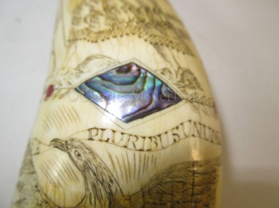 Lot 121 - Ø AN UNUSUAL SCRIMSHAW DECORATED WHALE'S TOOTH