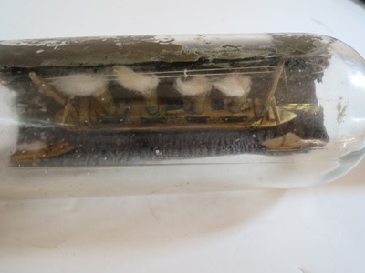 Lot 79 - A COMMEMORATIVE SHIP IN BOTTLE MODEL OF R.M.S. LUSITANIA MADE BY A SURVIVOR, 1915