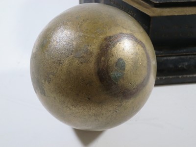Lot 144 - A 1905 TRAFALGAR CENTENARY CANNON BALL AND STAND COMMEMORATING H.M.S. VICTORY'S BATTLES