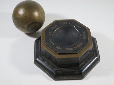 Lot 144 - A 1905 TRAFALGAR CENTENARY CANNON BALL AND STAND COMMEMORATING H.M.S. VICTORY'S BATTLES